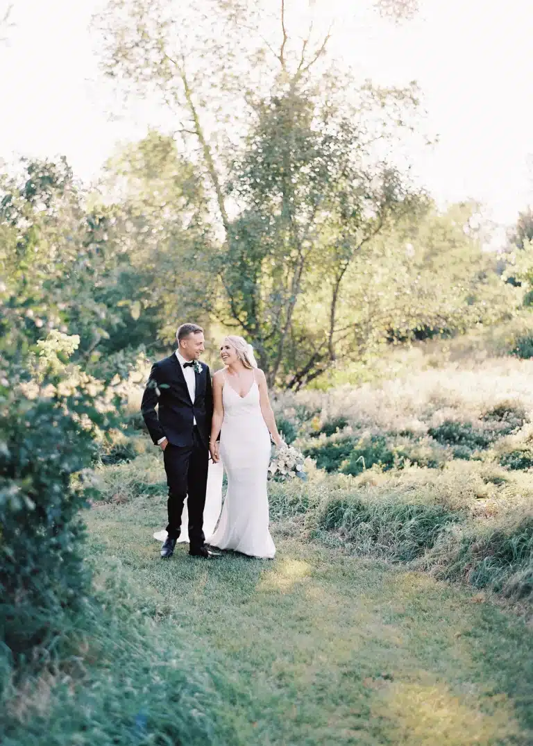 northrbook farm wedding bride groom walking 768x1075