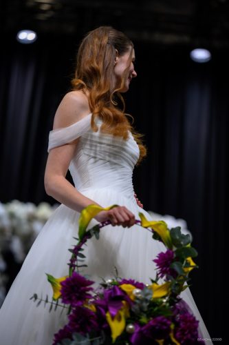 Canada's Bridal Show October 2026 - Bride with a purple floral basket bouquet on the runway