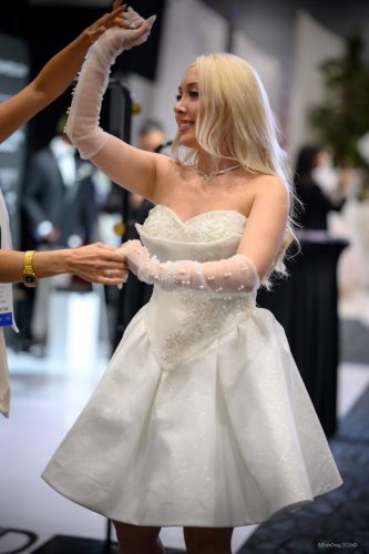 Canada's Bridal Show October 2026 - Bride trying on a short wedding dress at an exhibitor booth