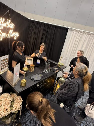 Canada's Bridal Show October 2026 - Exhibitor booth with a neon sign and visitors