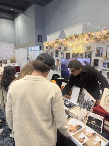 Canada's Bridal Show October 2026 - Photographer showing albums to visitors