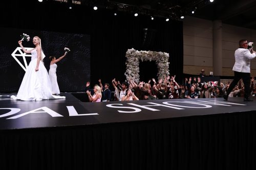 Canada's Bridal Show October 2026 - Crowd cheering during the bouquet toss beside the stage