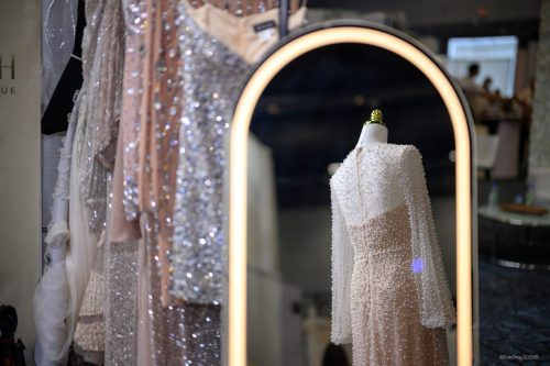 Canada's Bridal Show October 2026 - Sequin gowns and a lit arched mirror at a boutique booth