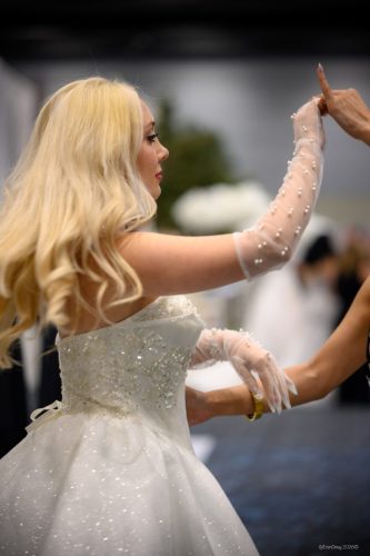 Canada's Bridal Show October 2026 - Stylist adjusting a model's gloves at a booth fitting